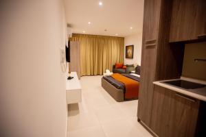 a hotel room with a bed and a couch at Global Ease in Accra