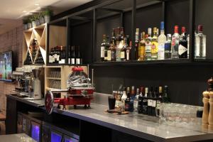 a bar with a bunch of bottles of alcohol at Campanile Shanghai Bund Hotel in Shanghai
