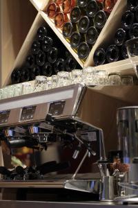 a kitchen with a counter with bottles of wine at Campanile Shanghai Bund Hotel in Shanghai