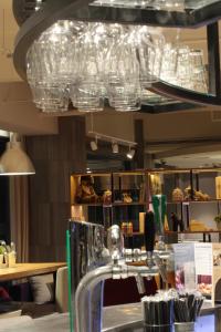 a restaurant with glasses hanging from a ceiling at Campanile Shanghai Bund Hotel in Shanghai