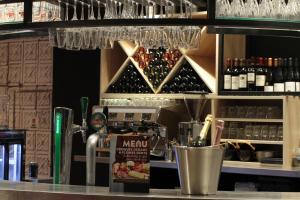 a bar with a counter with wine glasses at Campanile Shanghai Bund Hotel in Shanghai