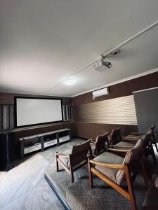 a waiting room with chairs and a flat screen tv at Paradiso Palazzo in Welkom