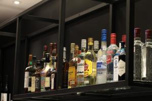 a bunch of bottles of alcohol on a shelf at Campanile Shanghai Bund Hotel in Shanghai