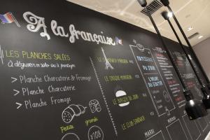 a chalkboard wall with a restaurant menu on it at Campanile Shanghai Bund Hotel in Shanghai