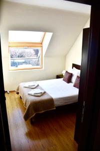 a bedroom with a large bed with a window at Luxury Chalet in Borovets, Rila Views & Fireplace in Borovets