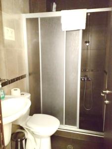 a bathroom with a shower and a toilet and a sink at Luxury Chalet in Borovets, Rila Views & Fireplace in Borovets