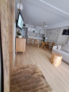 a living room with a white couch and a table at Pokoje Za Kinem in Duszniki Zdrój