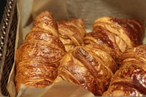 a bunch of croissants sitting in a basket at Campanile Shanghai Bund Hotel in Shanghai