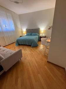 a bedroom with a bed and a table and a couch at Mater Domini in Chieti