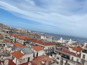 an aerial view of a city with buildings and the ocean at Appartement 3 pièces in LʼAgha