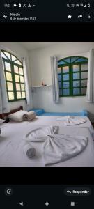 En eller flere senge i et værelse på Pousadinha encantos