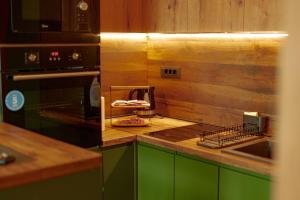 a kitchen with green cabinets and a counter top at Modern apartment with terrace in Petrovec in Petrovec +6 photos