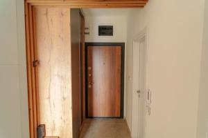 a hallway with a wooden door in a room at Modern apartment with terrace in Petrovec in Petrovec