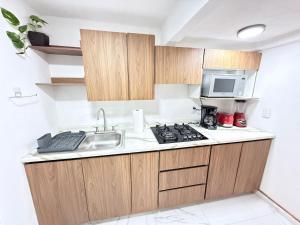 a kitchen with a sink and a microwave at Depto planta baja Cuautitlán izcalli in Cuautitlán Izcalli +18 photos