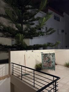 a bench in front of a wall with plants at Harhoura stay in Temara +4 photos