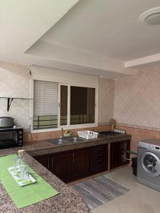 a kitchen with a sink and a counter top at Harhoura stay in Temara