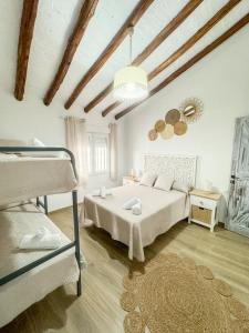 een slaapkamer met een bed en 2 stapelbedden bij Villa 68 by Villamya in Olvera