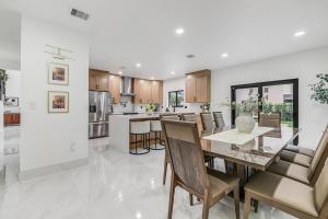 a kitchen and dining room with a table and chairs at Modern Miami Home with Patio and Pool in Country Walk