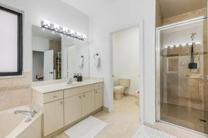 a bathroom with a shower and a sink and a mirror at Modern Miami Home with Patio and Pool in Country Walk +30 photos