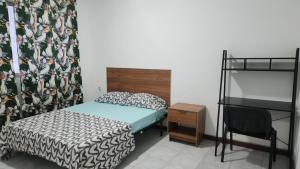 a bedroom with a bed and a chair and a bunk bed at Meeting Point Hostels-Praia Beachwalk-NO CASH ACCEPTED-Also in Fogo & Tarrafal in Praia