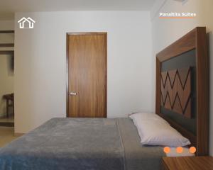 a bedroom with a bed and a wooden door at PanaltitaSuites in Cancún +18 photos
