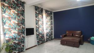a brown chair in a room with blue walls at Meeting Point Hostels-Praia Beachwalk-NO CASH ACCEPTED-Also in Fogo & Tarrafal in Praia +47 photos