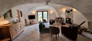 a living room with a stone fireplace and chairs at Chalet Le Chatelret - LE CHATELRET MAE-9361 in Vars