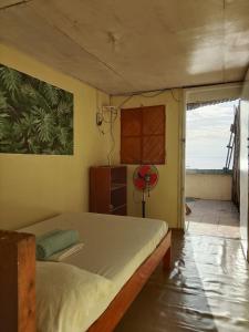 a bedroom with a bed and a view of the ocean at Pescador View - Beachfront ,Extensions & nearby the Ocean Hostels & Restaurant Moalboal in Moalboal