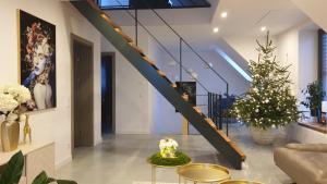 a living room with a staircase and a christmas tree at ArtApart in Strzelce Opolskie