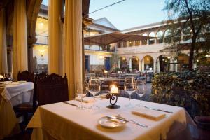 a table in a restaurant with a candle on it at Palacio del Inka, a Luxury Collection Hotel, Cusco in Cusco