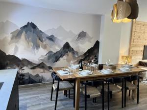 a dining room with a mountain mural on the wall at Chalet N°5 - CHALET PRESTIGE 9 P. PROCHE PISTES-Tout inclus MAE-4253 in Vars