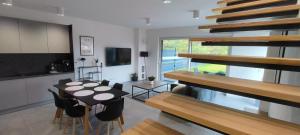 a kitchen and dining room with a table and chairs at Wilga House 1 in Piła