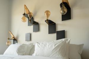 a bedroom with a bed and some lights on the wall at B&B Panevì in San Marcello