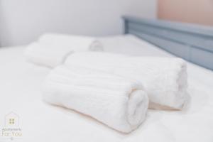 a bed with two white towels on it at Apartamenty For You in Bystrzyca Kłodzka +25 photos