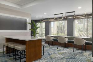 a conference room with a table and chairs at SpringHill Suites Boca Raton in Boca Raton +23 photos