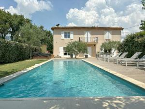 ein Swimmingpool vor einem Haus in der Unterkunft Modern Provençal Villa At The Forest's Edge in Le Tignet