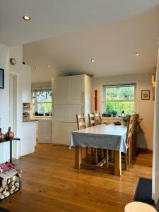 eine Küche und ein Esszimmer mit Tisch und Stühlen in der Unterkunft Modern Cabin With Panoramic Views In Aukland in Høyvik + 23 Fotos