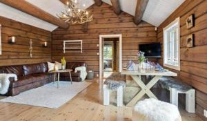 un soggiorno con un divano e un tavolo di Timber Cabin With Soul At Kvamskogen a Norheimsund