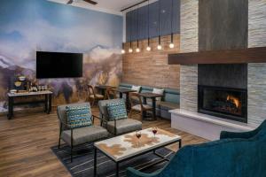 a lobby with a fireplace and chairs and a tv at Marriott's Mountain Valley Lodge at Breckenridge in Breckenridge