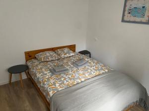 a bedroom with a bed with a wooden headboard at Guests House in La Vespière +6 photos