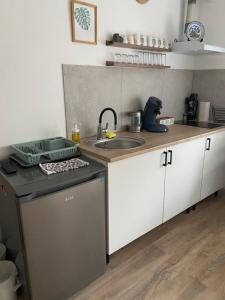 a kitchen with a sink and a dishwasher at Guests House in La Vespière