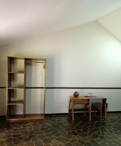 a room with a table and a book shelf at Aranwa Sarapiquí Rainforest Lodge in Sarapiquí
