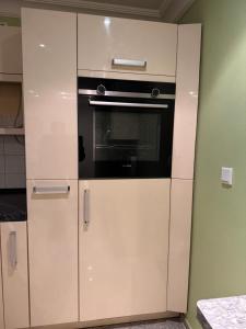 eine Küche mit weißen Schränken und einem Backofen in der Unterkunft Vermietung Daniel in Nürnberg + 9 Fotos