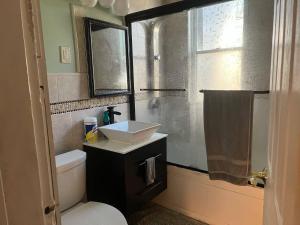 a bathroom with a sink and a toilet and a window at Casa Castor • Private Room 2 in Chelsea