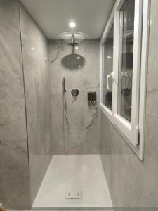 a bathroom with a shower with a glass door at Casa con vista in Ariccia +47 photos