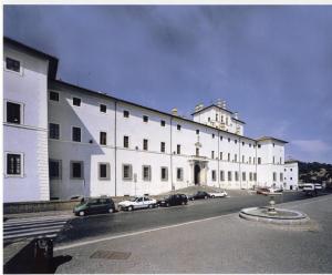a large white building with cars parked in front of it at Casa con vista in Ariccia