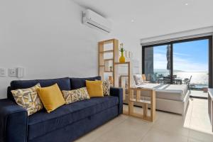 a living room with a blue couch and a table at Modern Ocean View Apartment Private Balcon in Nuevo Nayarit +20 photos
