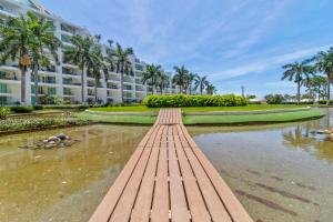 a bridge over a body of water in front of a building at Modern Ocean View Apartment Private Balcon in Nuevo Nayarit