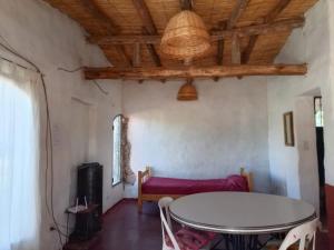 a living room with a table and a couch at Nativas Cabaña Amarilla in Senador Pérez