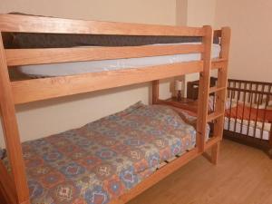 a couple of bunk beds in a room at Logement du Bois de Chaubon in Fillinges